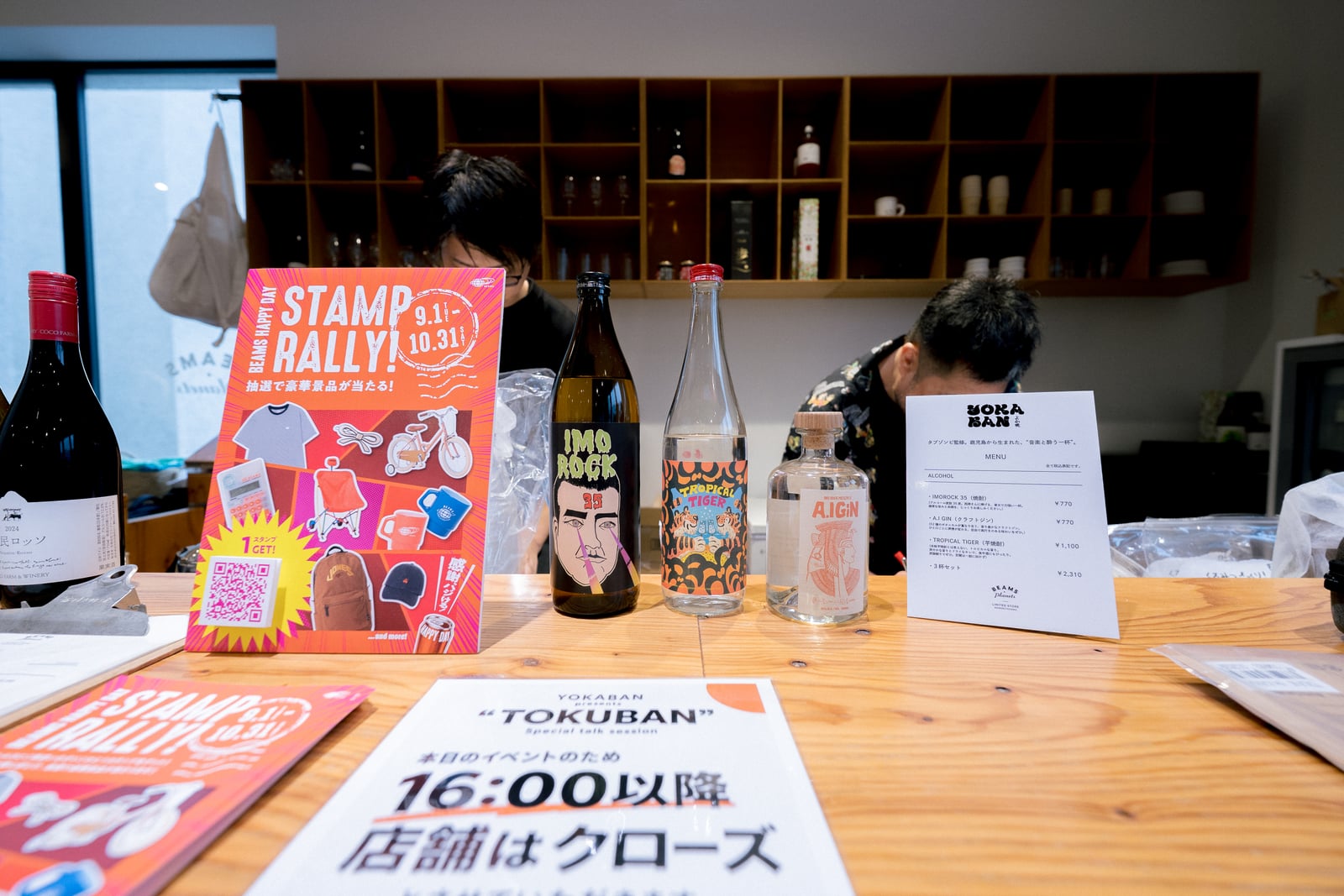 焼酎やジンのボトルとメニューが並ぶカウンター